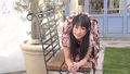 Reina on all fours on garden bench long hair wearing brown dress